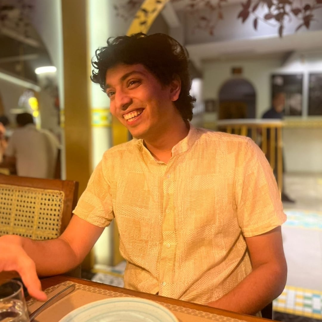 Rohan smiling at a restaurant